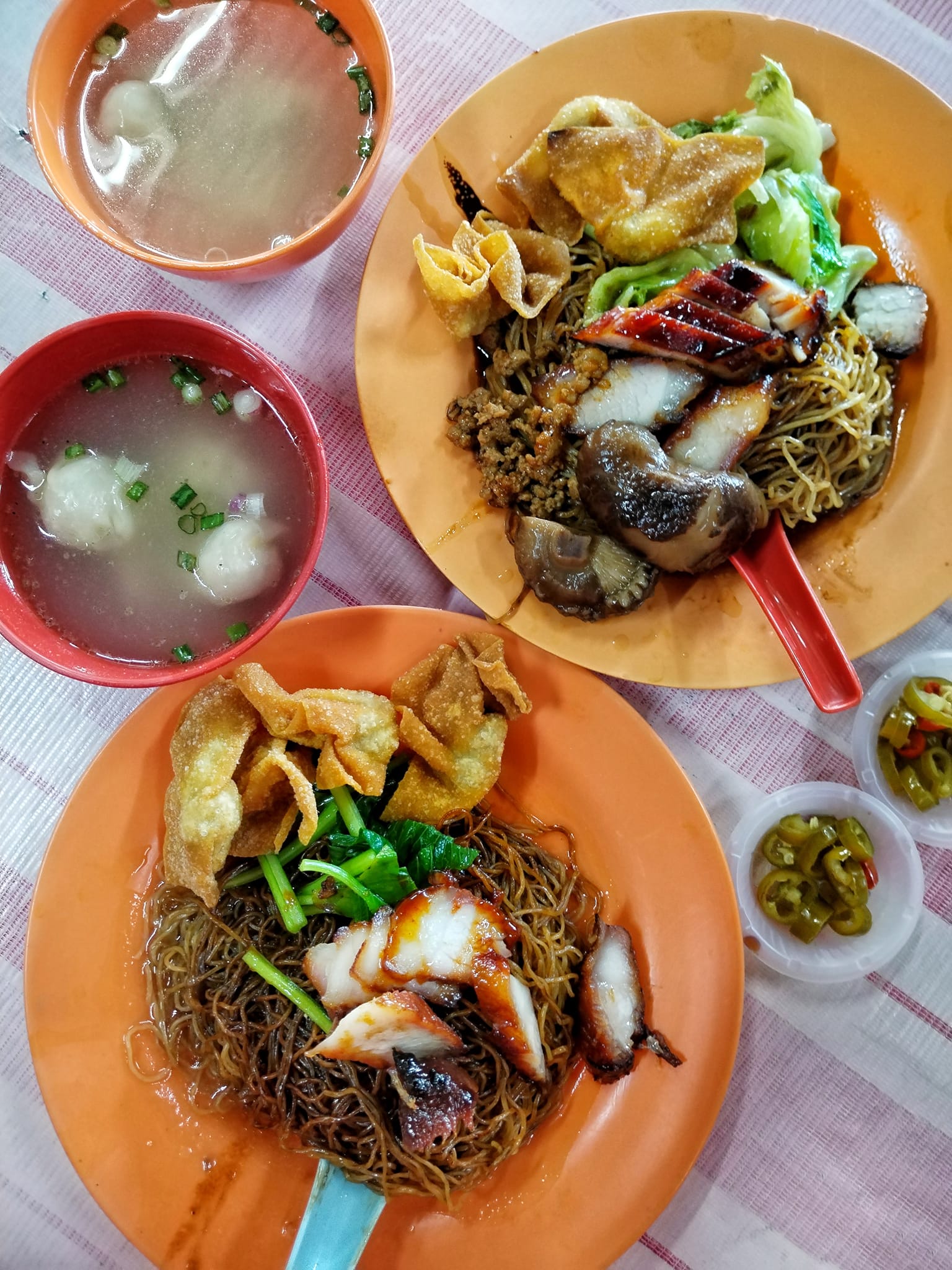 Two plates with pork and noddle